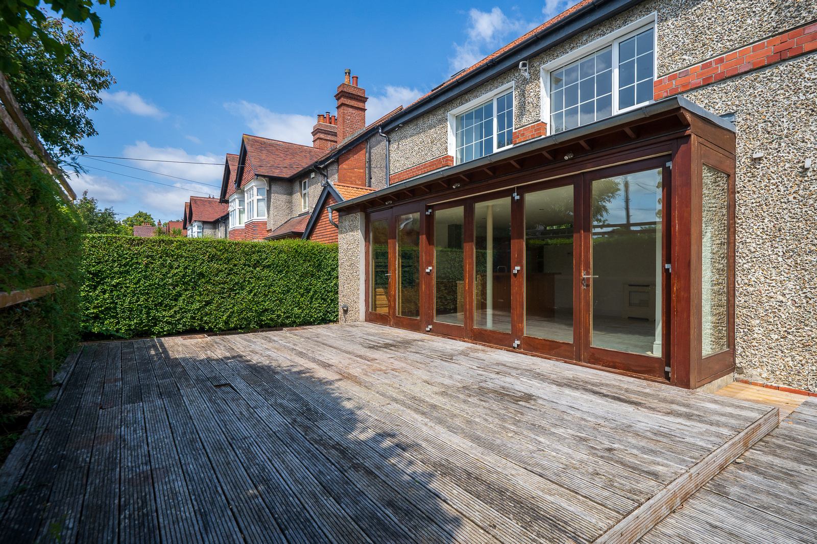 Stone house exterior with glass garden extension