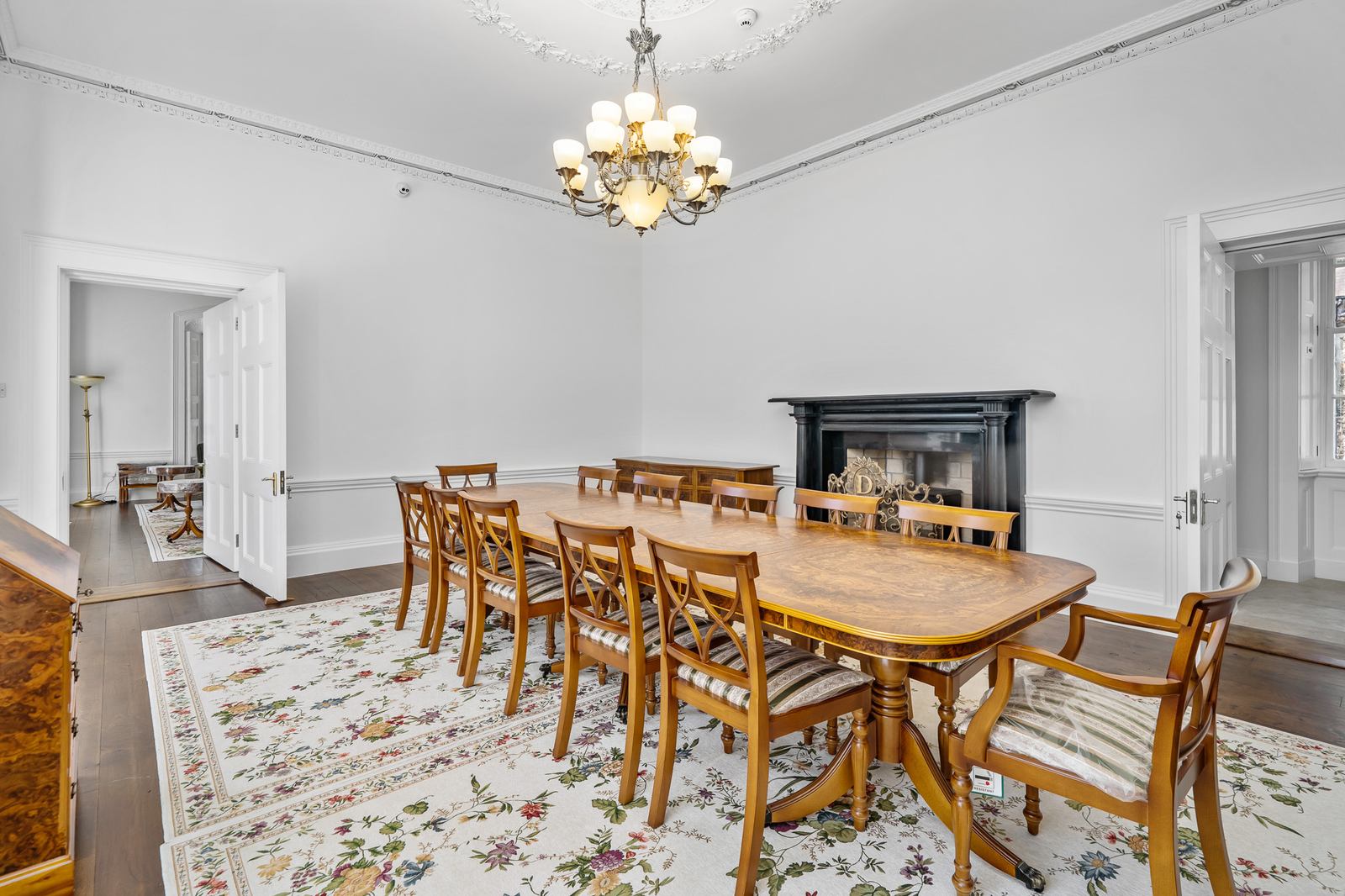 Grand sitting room with period fireplace and ornate details